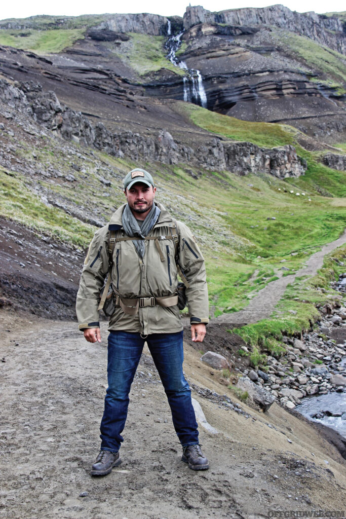 Photo of Kevin Estela standing in front of some rocky protrusions.