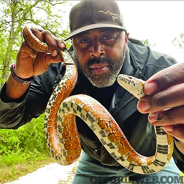 Britt Ahart holding up a live snake.