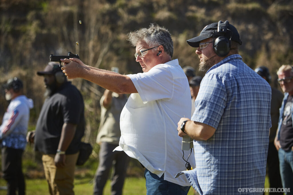 Photo of John Hearne supervising handgun training.