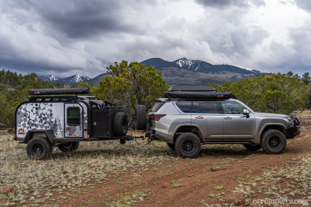 Photo of the Overland Expo 2023 Ultimate Overland Vehicle, a Lexus LX600 equipped with overlanding gear and towing a Pando 2.0 teardrop trailer.