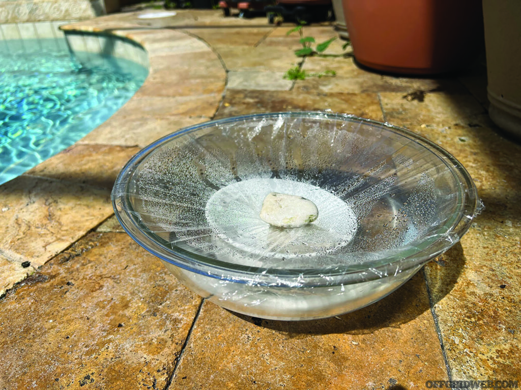 Photo of a solar still being used to distill salt water as a water purification method.